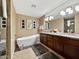 Luxurious bathroom with a soaking tub, double vanity, and walk-in shower at 9223 E Whitethorn Cir # 667, Scottsdale, AZ 85266