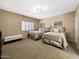 Guest bedroom with two twin beds and a window with plantation shutters at 9223 E Whitethorn Cir # 667, Scottsdale, AZ 85266