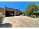 Front view of a tan stucco home with a two-car garage and driveway at 9223 E Whitethorn Cir # 667, Scottsdale, AZ 85266