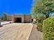 Tan stucco exterior with two-car garage and desert landscaping at 9223 E Whitethorn Cir # 667, Scottsdale, AZ 85266