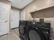 Laundry room with Samsung washer and dryer, shelving, and tile flooring at 9223 E Whitethorn Cir # 667, Scottsdale, AZ 85266