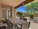 Covered patio with outdoor dining furniture and desert landscaping at 9223 E Whitethorn Cir # 667, Scottsdale, AZ 85266