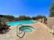 Community pool and spa with lounge chairs and a covered patio area at 9223 E Whitethorn Cir # 667, Scottsdale, AZ 85266