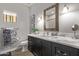 Bathroom boasts a marble vanity, subway tile, and elegant mirror at 943 E Kortsen Rd # 10, Casa Grande, AZ 85122