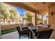 Covered patio with seating area, chandelier, and view of the backyard at 943 E Kortsen Rd # 10, Casa Grande, AZ 85122