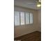 Bedroom with wood flooring, plantation shutters, and ceiling fan at 10216 W Ironwood Dr, Sun City, AZ 85351