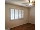 Bedroom with wood flooring and plantation shutters at 10216 W Ironwood Dr, Sun City, AZ 85351