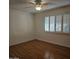 Bedroom with wood flooring, ceiling fan and shutters at 10216 W Ironwood Dr, Sun City, AZ 85351