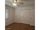 Bedroom with large closet and wood flooring at 10216 W Ironwood Dr, Sun City, AZ 85351