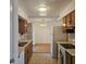 Kitchen with wood cabinets, tile floor, and appliances at 10216 W Ironwood Dr, Sun City, AZ 85351