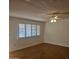 Living room with wood flooring, ceiling fan, and window shutters at 10216 W Ironwood Dr, Sun City, AZ 85351