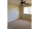 Spacious bedroom with ceiling fan and carpet flooring at 10526 W Crosby Dr, Sun City, AZ 85351