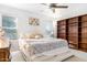 Main bedroom with a ceiling fan and built in shelving at 10555 E Bella Vista Dr, Scottsdale, AZ 85258