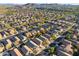 Aerial view of a large community with numerous houses and a mountain backdrop at 10808 W Cottontail Ln, Peoria, AZ 85383