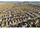 Aerial image showcasing a residential area with houses, roads, and desert landscape at 10808 W Cottontail Ln, Peoria, AZ 85383