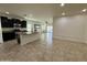 Modern kitchen with island, stainless steel appliances, and tiled floor at 10808 W Cottontail Ln, Peoria, AZ 85383