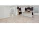 Kitchen with dark cabinets, granite island and tile floor at 10808 W Cottontail Ln, Peoria, AZ 85383