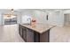 Kitchen island with granite countertop and double sink overlooking backyard at 10808 W Cottontail Ln, Peoria, AZ 85383