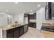 Open kitchen features granite island, stainless steel appliances, and dark cabinetry at 10808 W Cottontail Ln, Peoria, AZ 85383