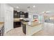 Bright kitchen boasts granite island, stainless steel appliances, and ample cabinet space at 10808 W Cottontail Ln, Peoria, AZ 85383