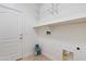 Laundry room with built-in shelving and ample storage space at 10808 W Cottontail Ln, Peoria, AZ 85383