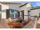Charming patio area with firepit and wooden chairs near the home entrance at 10808 W Cottontail Ln, Peoria, AZ 85383