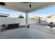 Covered patio with ceiling fan adjacent to the pool at 10808 W Cottontail Ln, Peoria, AZ 85383