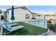 Modern backyard retreat with a sparkling pool and comfortable lounge chairs at 10808 W Cottontail Ln, Peoria, AZ 85383