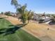 Home nestled on a golf course with mature trees, aerial view at 10846 E Navajo Dr, Sun Lakes, AZ 85248