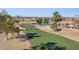 Aerial view of a community with golf course, lake, and homes at 10846 E Navajo Dr, Sun Lakes, AZ 85248