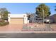 Single story home with tan colored garage and desert landscaping at 10846 E Navajo Dr, Sun Lakes, AZ 85248
