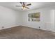 Spacious bedroom with ceiling fan and neutral carpeting at 11530 E Marguerite Ave, Mesa, AZ 85208