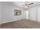 Bedroom featuring ceiling fan, neutral carpeting, and large window at 11530 E Marguerite Ave, Mesa, AZ 85208