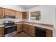 Kitchen features wood cabinets, stainless steel appliances, and dishwasher at 11530 E Marguerite Ave, Mesa, AZ 85208