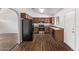 Kitchen features wood cabinets, stainless steel appliances, and laminate floors at 11530 E Marguerite Ave, Mesa, AZ 85208