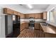 Kitchen boasts wood cabinets, stainless steel appliances, and laminate floors at 11530 E Marguerite Ave, Mesa, AZ 85208