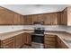 View of kitchen with wood cabinets and stainless steel appliances at 11530 E Marguerite Ave, Mesa, AZ 85208