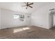 Spacious living room with neutral carpet and ceiling fan at 11530 E Marguerite Ave, Mesa, AZ 85208