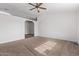 Spacious living room with neutral carpet and ceiling fan at 11530 E Marguerite Ave, Mesa, AZ 85208