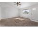 Spacious living room with neutral carpet and ceiling fan at 11530 E Marguerite Ave, Mesa, AZ 85208