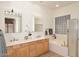 Bathroom features double sinks, a large soaking tub, and a glass block window at 1201 W Ducasse Dr, Phoenix, AZ 85013