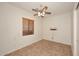 Simple bedroom with tile flooring and ceiling fan at 1201 W Ducasse Dr, Phoenix, AZ 85013