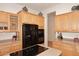 Kitchen boasts black appliances and light wood cabinets at 1201 W Ducasse Dr, Phoenix, AZ 85013
