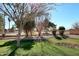 Landscaped yard with trees, grass, and curved border at 1201 W Ducasse Dr, Phoenix, AZ 85013
