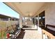 Covered patio with brick pavers, seating area, and ceiling fan at 1201 W Ducasse Dr, Phoenix, AZ 85013