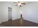 Bedroom with wood floors, ceiling fan and access to bathroom at 14905 W Ashland Ave, Goodyear, AZ 85395