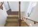 Elegant staircase with wood railings and carpeted steps at 14905 W Ashland Ave, Goodyear, AZ 85395