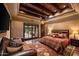 Bedroom with patio access and wood beamed ceiling at 16117 E Shooting Star Trl, Fountain Hills, AZ 85268