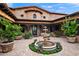 Inviting courtyard with a decorative fountain, stone accents, and lush potted plants enhancing its elegance at 16117 E Shooting Star Trl, Fountain Hills, AZ 85268