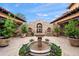 Charming courtyard featuring a stone fountain, manicured plants, and architectural stone detailing at 16117 E Shooting Star Trl, Fountain Hills, AZ 85268